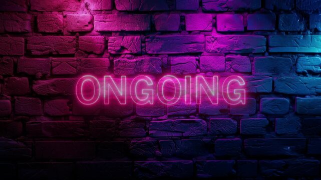Video footage of Pink glowing On Going text, typography neon on brick wall background. Looped Neon abstract Lines.