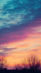 A stunning sunset with vibrant colors and silhouetted trees, evoking a sense of peace and tranquility in nature.