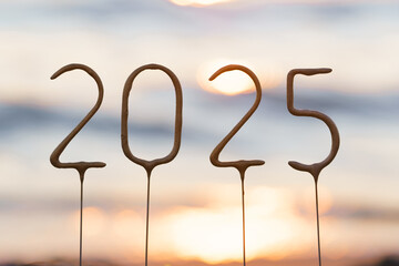 Close-up of the number 2025 against the background of sunset and sparkling sea water. The beginning...