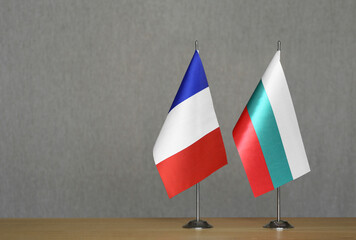 Table flags of France and Bulgaria on a gray blurred background