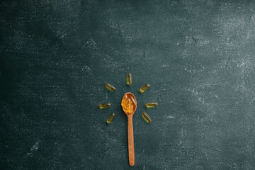 Omega 3 vitamins on dark background, copy space
