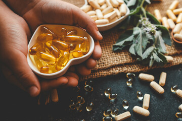 Natural organic vitamins in hands close-up