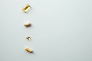 Different vitamins on white background, banner healthcare and medicine