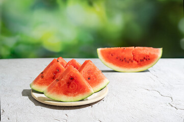Wedges of watermelon lies on a table outdoors, summer.