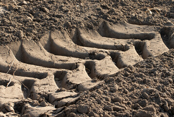 Wheel marks of a heavy tractor working on a field