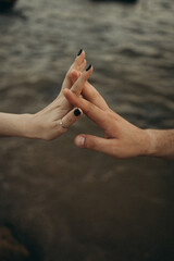 two hands holding each other