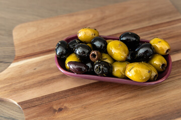 Bowl of olives on the cutting board