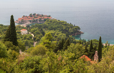 Naklejka premium Aerial view over St Stephan island, turquoise sea and mountains from the viewpoint at the mountain. Budva, Montenegro 