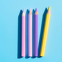 Colorful crayons and pencils arranged on a pastel blue paper background viewed from above