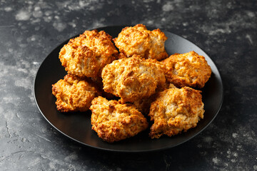 Homemade Cheddar Cheese Biscuits on a black plate
