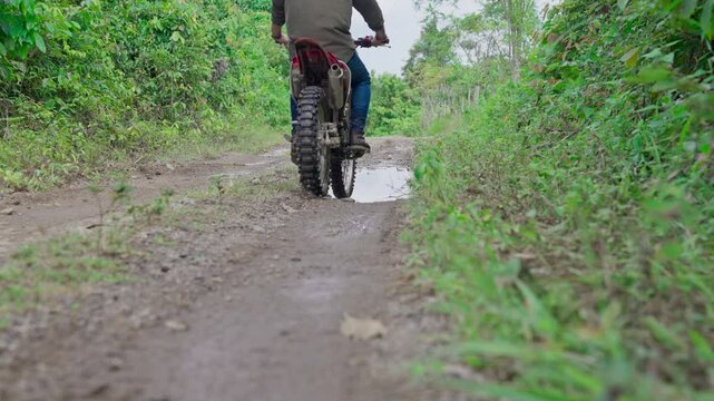 Slow motion video of a man goes on an adventure using an enduro motorbike
