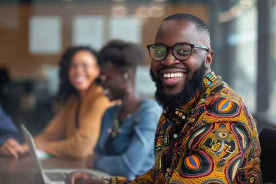 A man smiling and working on his laptop, perfect for corporate or personal use