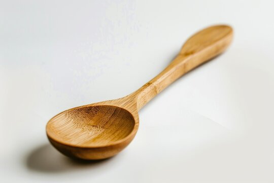 A simple wooden spoon rests on a flat surface