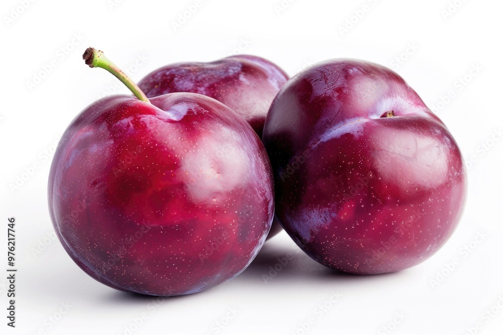 Poster a still life image of three plums arranged together on a white surface