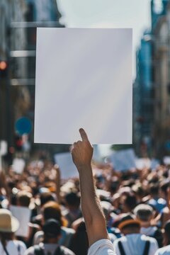 Blank mockup of a bold and eyecatching flyer for a political rally or campaign event, someones hand holding empty poster in crowd surrounding