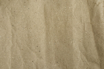 Recycled brown paper, with wrinkled and crumpled texture, with creases, and volumetric shadows