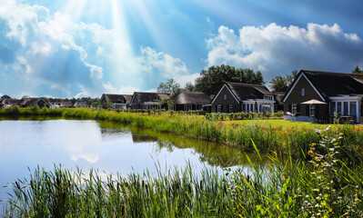 Someren (De Heihorsten Bungalowpark), Netherlands - August 9. 2024: Beautiful idyllic vacation bungalows by a pond