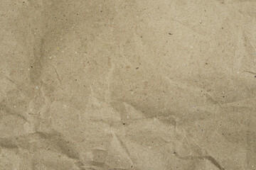 Recycled brown paper, with wrinkled and crumpled texture, with creases, and volumetric shadows