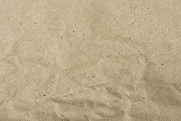 Recycled brown paper, with wrinkled and crumpled texture, with creases, and volumetric shadows