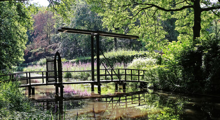 Old wooden dutch drawbridge over castle water moat - Kasteel Heeze, Netherlands