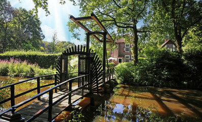 Old wooden dutch drawbridge over castle water moat - Kasteel Heeze, Netherlands