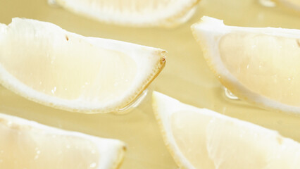 Macro of a fresh lemon slices arranged on yellow background. Close up of citrus fruit or lemon sliced placed at red backdrop. Citrus composition concept. Design for greeting card, wallpaper. Pabulum.