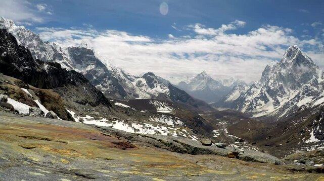 Panoramic view of mountain valley in Himalayas with Mount Lobuche in the left, Mounts Cholatse and Tobuche in the right and Mount Ama Dablam in the middle. Time lapse video. Natural landscapes theme.