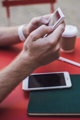 Faceless male spending time in street coffee bar