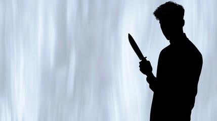 Silhouette of a man holding a knife standing against a blue background with copy space. Concept of psychopath is waiting for a victim.