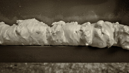Filling the space in a steel garage door using polyurethane foam.