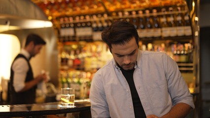 Profile closeup of smiling smart man in white shirt drinking cocktail in Old fashioned of special party beverage vibrant at nightclub on Friday meeting night time at luxurious counter bar. Vinosity.