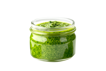 Glass jar of fresh green pesto sauce with basil leaves isolated on a white transparent background. Concept of homemade food and healthy eating
