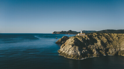 defaultwhite small lighthouse on the coast of the mediterranean sea