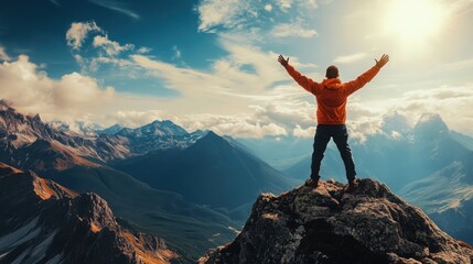 Person standing on the top of the mountain with his hands to the side 