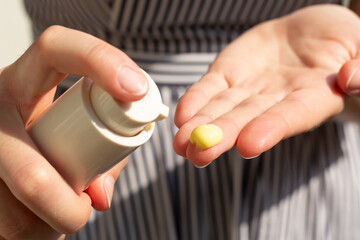 Closeup of a woman using retinal serum.