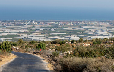 A distant view of Atayurt as a summer resort on the Mediterranean coast  in the summer season and agricultural production area with intensive greenhouses
