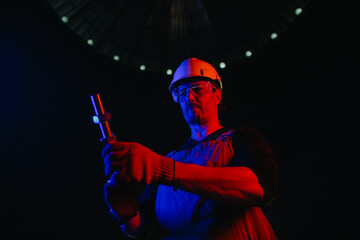 Worker at construction site in neon light