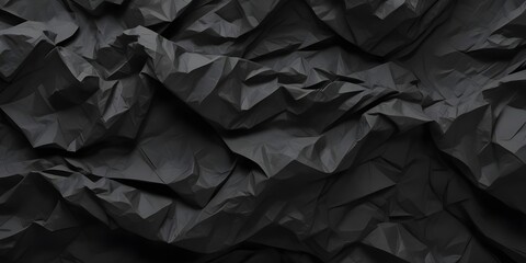 Abstract dark crumpled paper texture with deep folds and creases, creating a moody, tactile surface with shadows and highlights.
