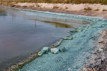 Blue chemical plant emissions on the river - ecological disaster