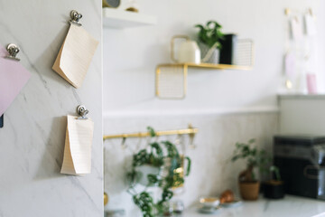 Notes and plants decorate a modern kitchen with marble accents and gold shelves during daylight