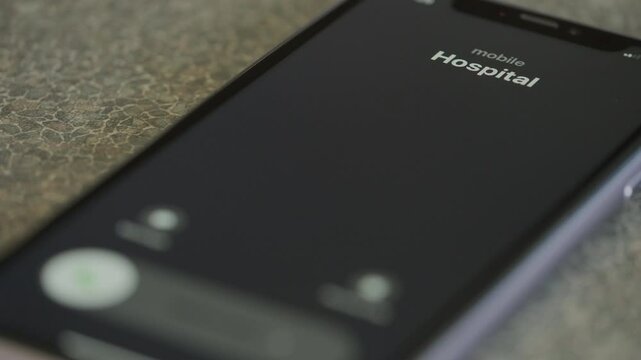 Incoming call from hospital on smartphone macro video.