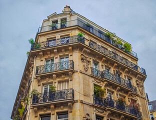 Elegant Parisian building facade with balconies and attics. Typical building in Paris, France.