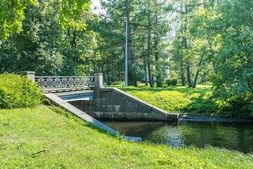 A bridge over a river with a green grassy area on the other side