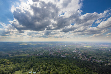 Fototapeta premium A city with a lot of trees and a cloudy sky