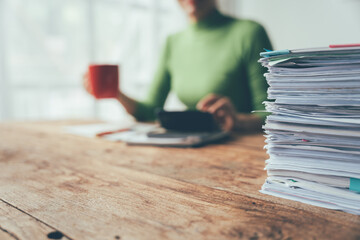 Overwhelmed: The Looming Threat of Deadlines - A mountain of paperwork overshadows a busy...