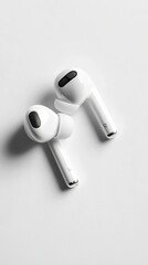 Wireless earbuds displayed in a flat lay format against a minimalist white backdrop