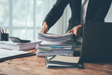 The Paper Mountain: A close-up shot of a businesswoman's hands struggling to manage a towering...