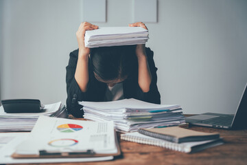 Overwhelmed by Paperwork: A business professional sits at their desk, buried under a mountain of...