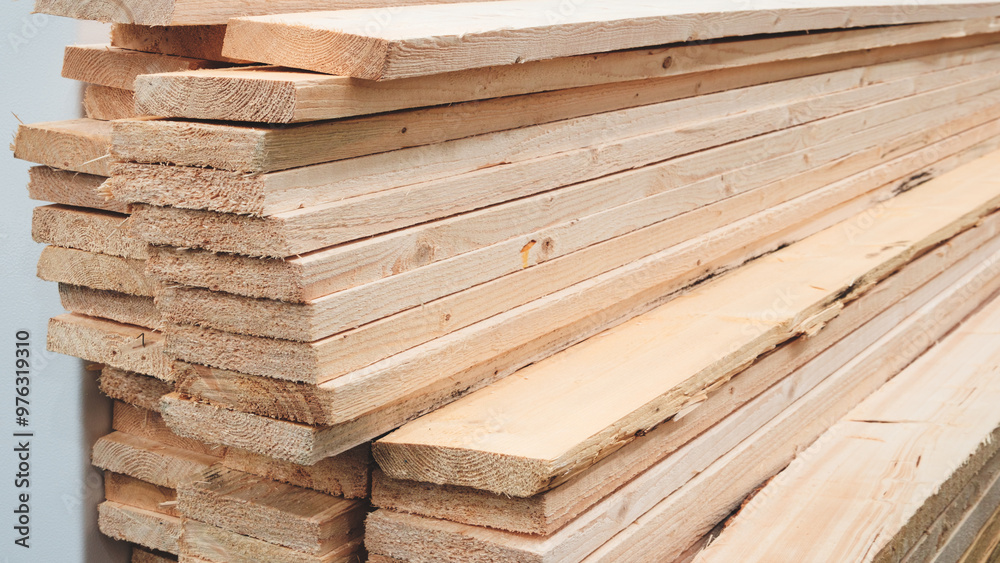 Poster a stack of wood planks with some of them being cut. concept of hard work and dedication
