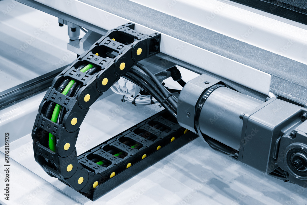 Poster a machine with a black and green cable running through it